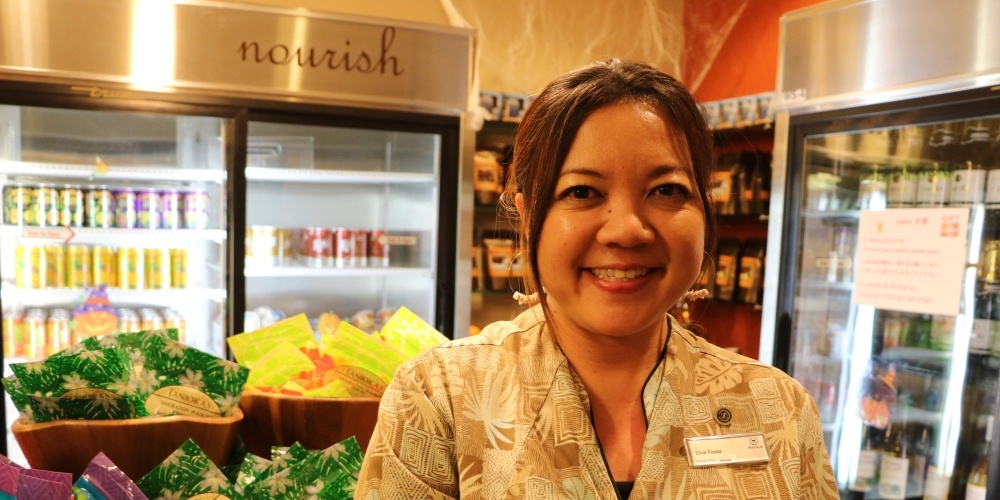 woman standing in front of commercial refrigerator