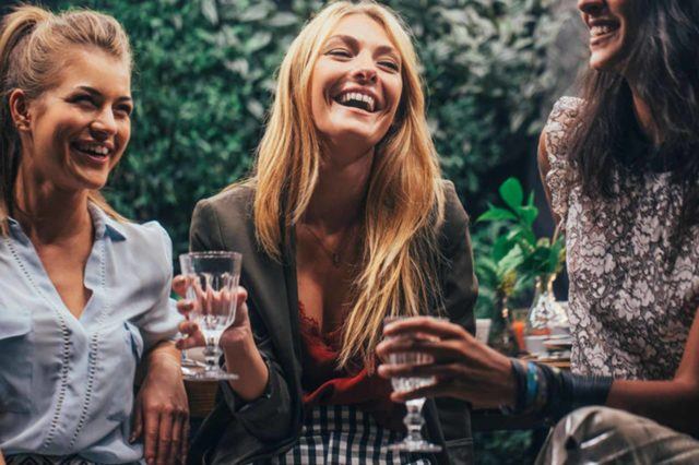three women holding wine glass