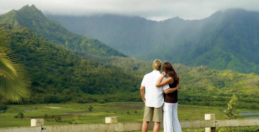 man and woman standing while looking to mountains during daytime