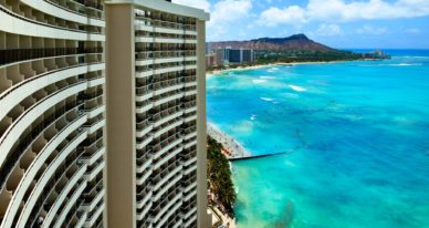 white high rise building in front of water
