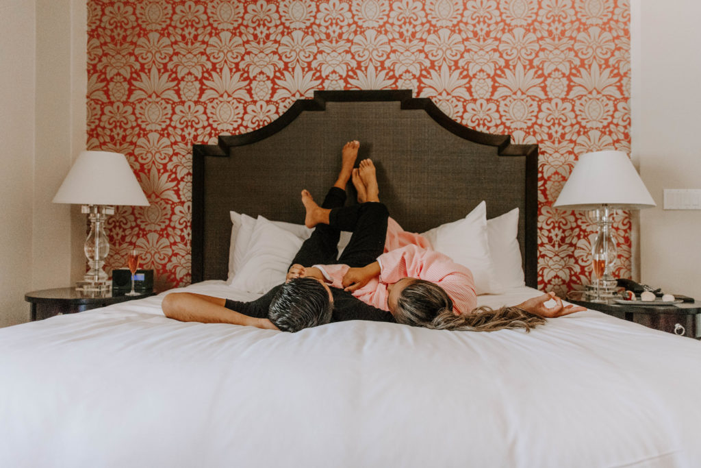 man and woman lying on bed inside room