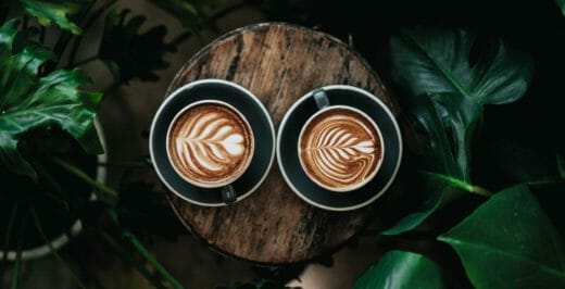 two coffee latte on log