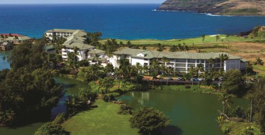 aerial view of kauai beachfront resort with lakes in the foreground